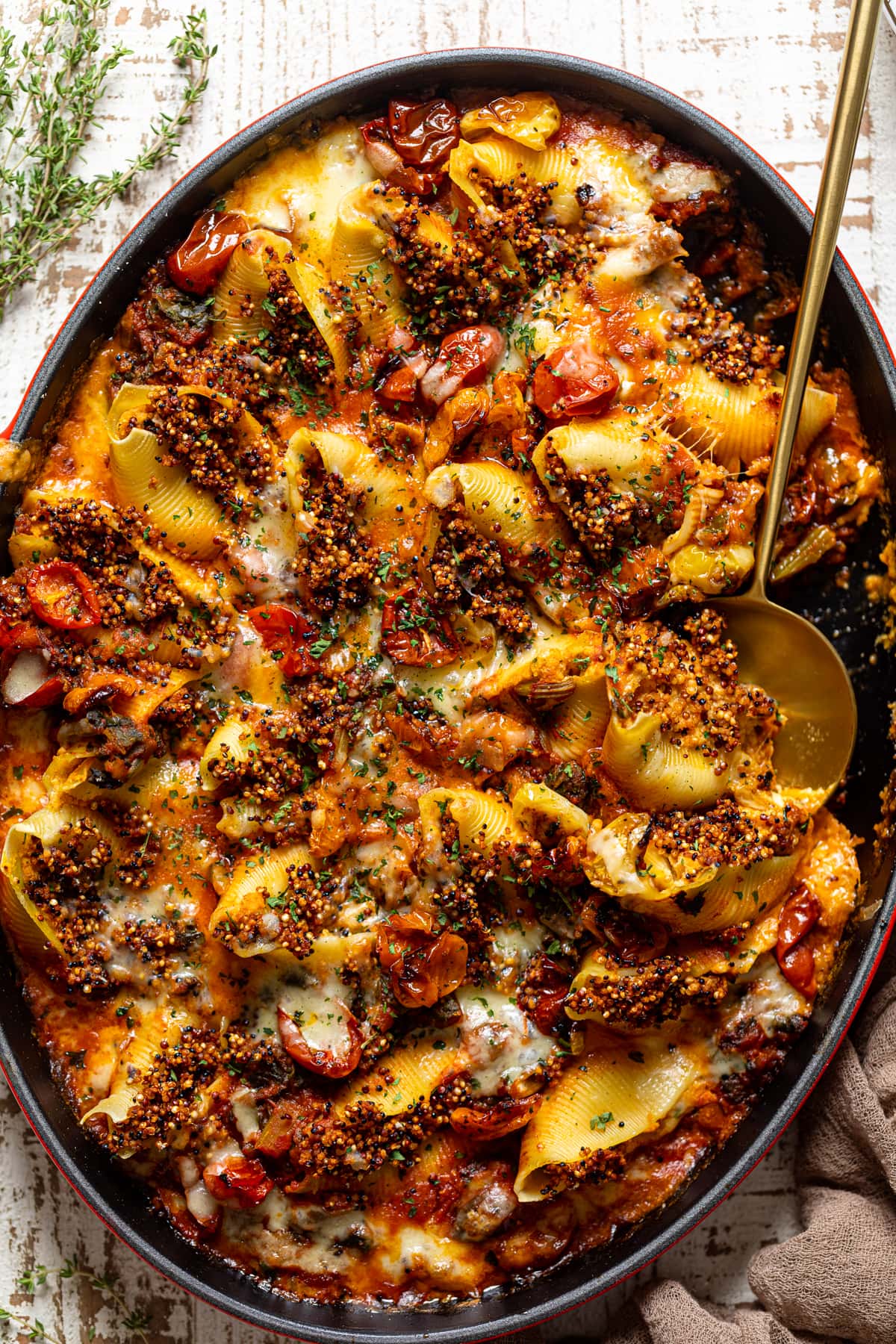 Serving spoon scooping Butternut Squash Stuffed Shells with Quinoa and Kale
