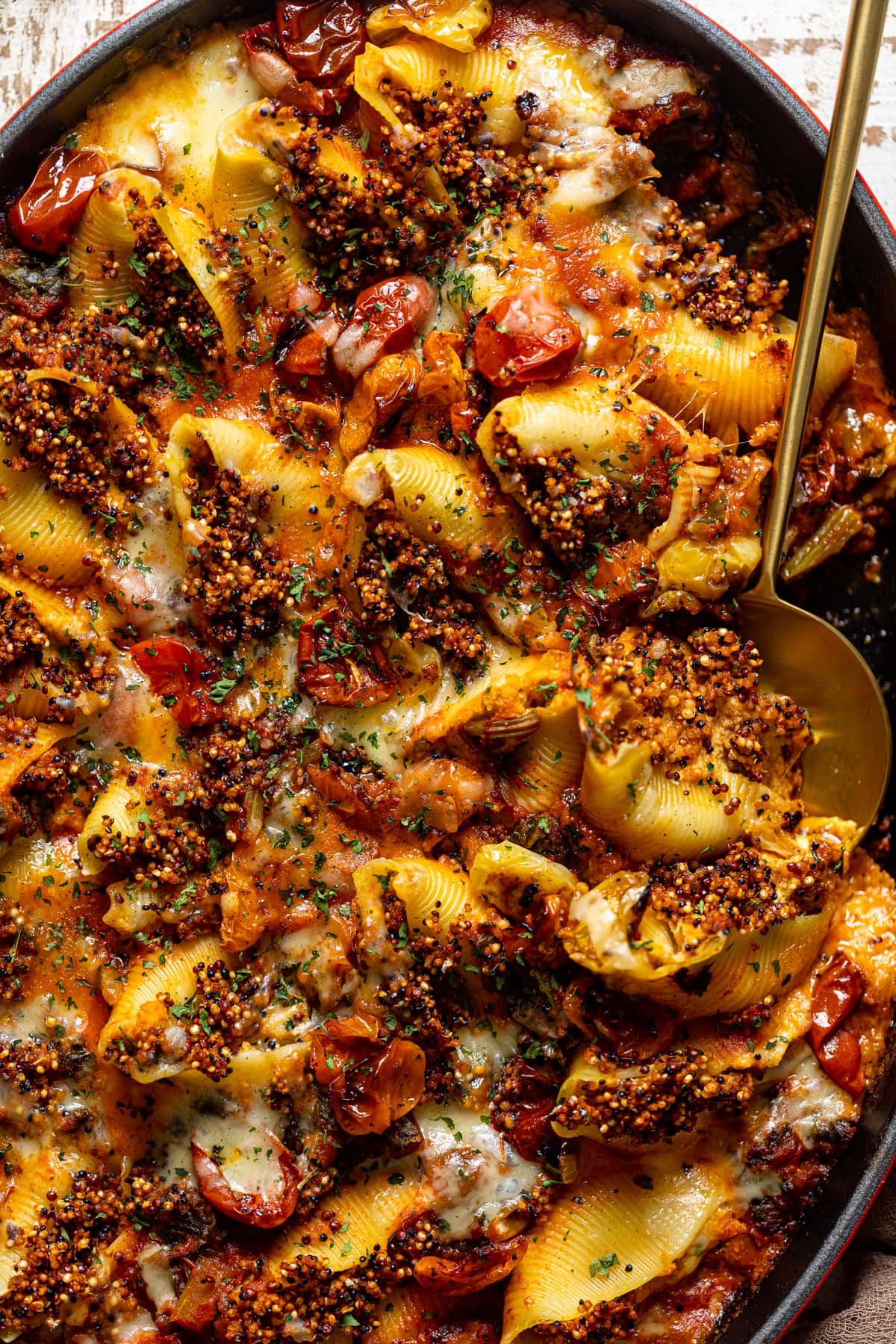 Closeup of a serving spoon in Butternut Squash Stuffed Shells with Quinoa and Kale