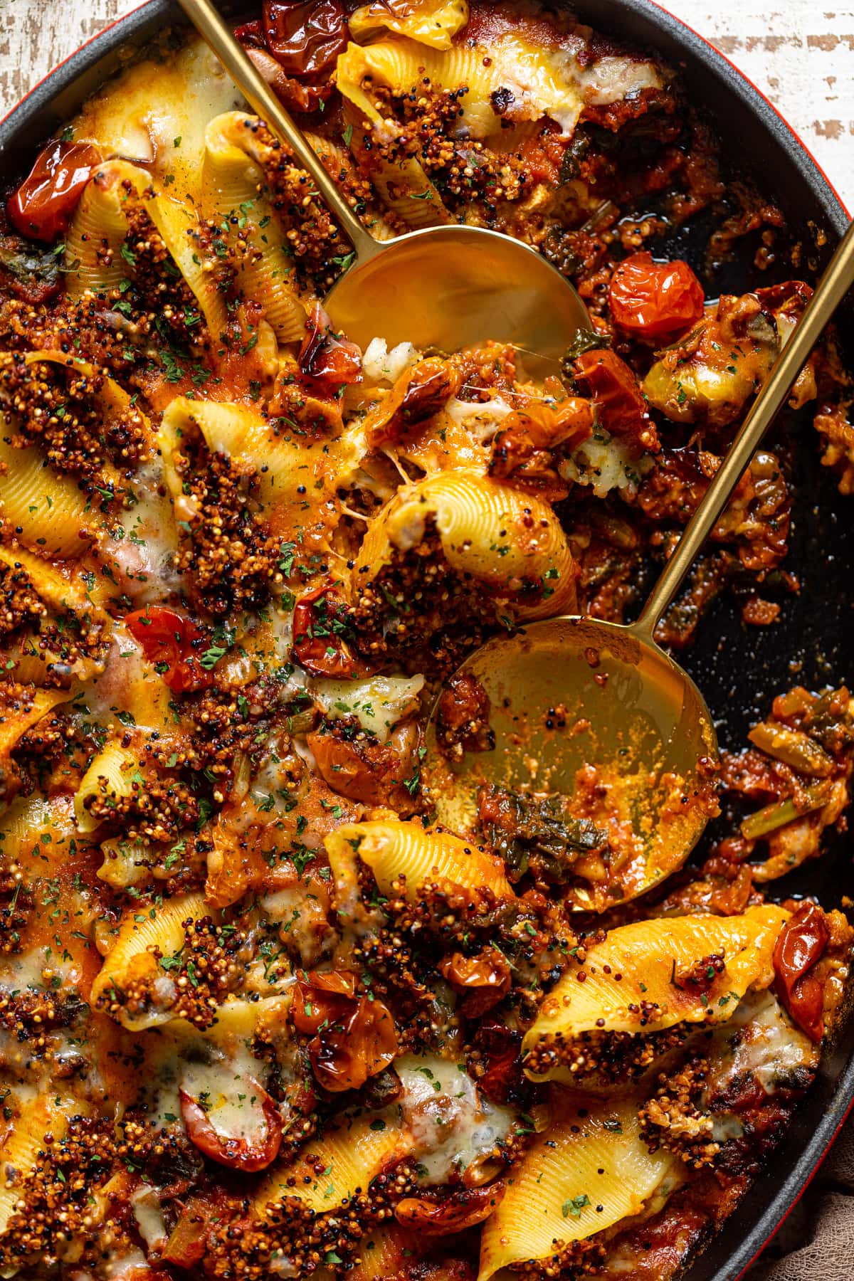 Closeup of two serving spoons in Butternut Squash Stuffed Shells with Quinoa and Kale