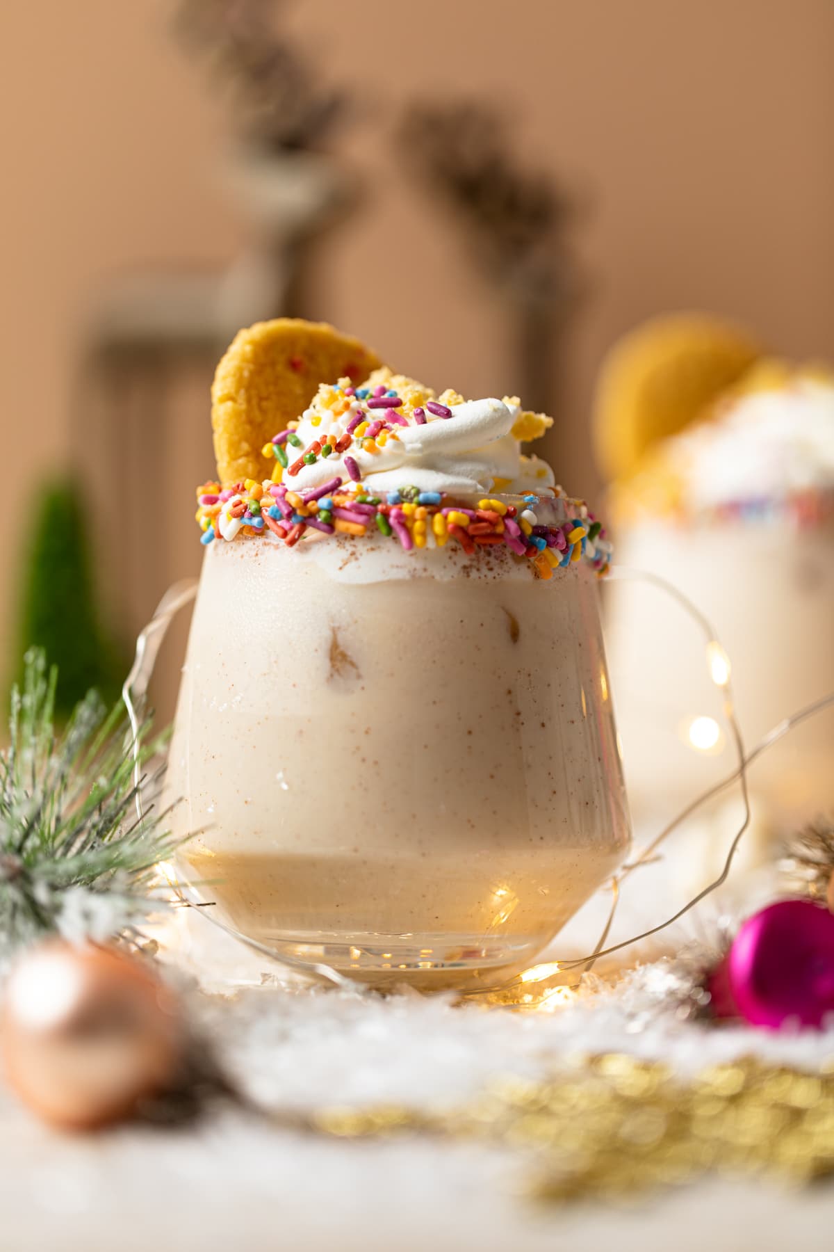 Cookie drink topped with whipped cream, sprinkles.