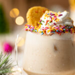 Closeup of a Sugar Cookie Mocktail topped with whipped cream, sprinkles, and a sugar cookie