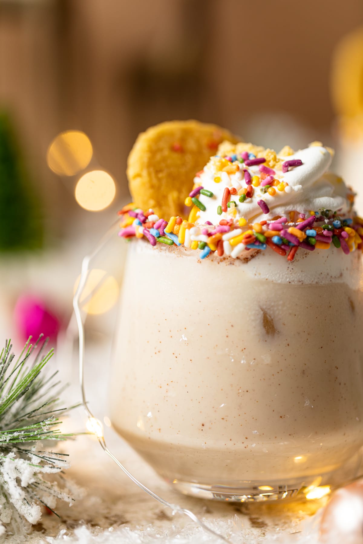 Closeup of a Sugar Cookie Mocktail topped with whipped cream, sprinkles, and a sugar cookie