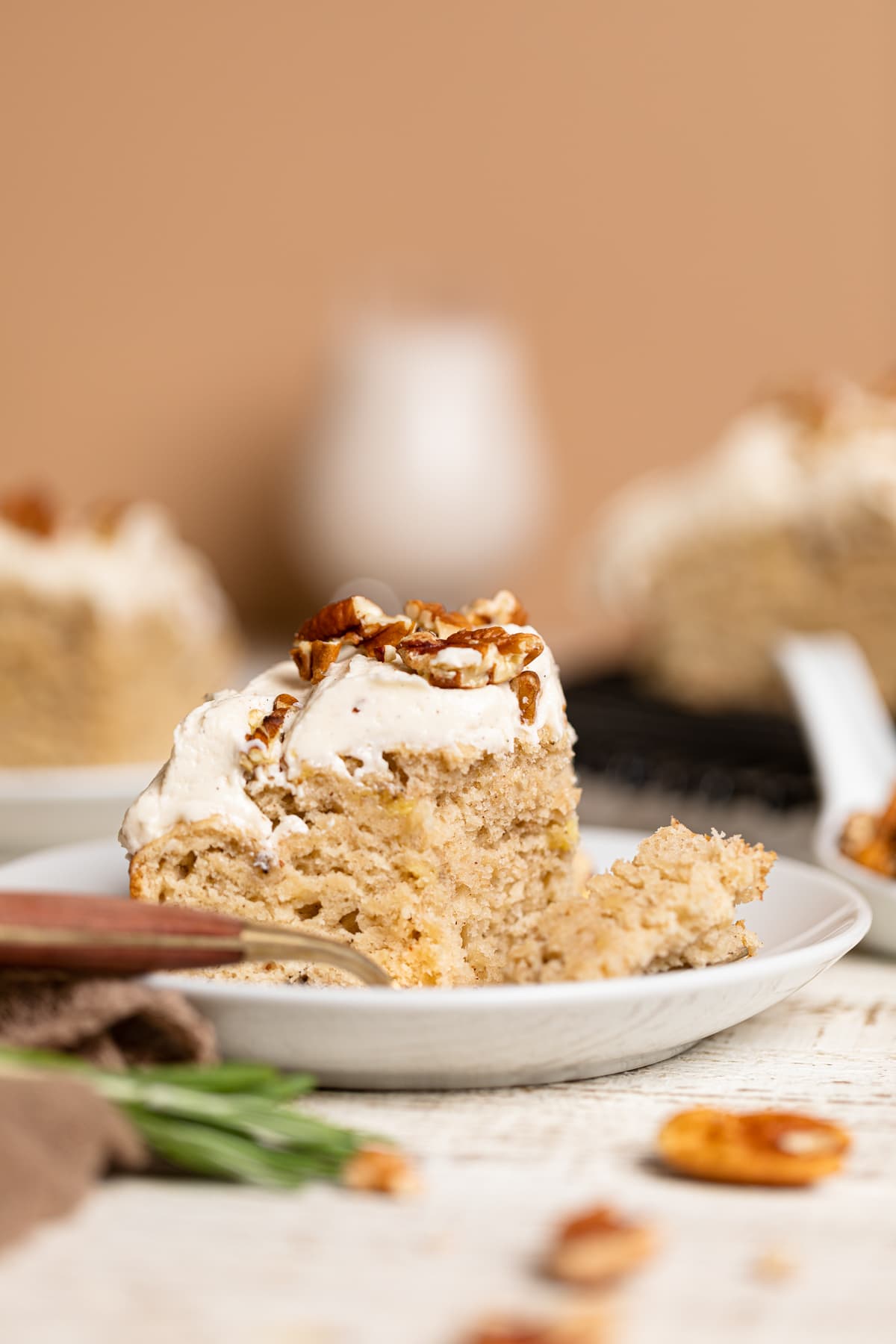 Piece of Sheet Cake topped with pecans on a small plate with a fork