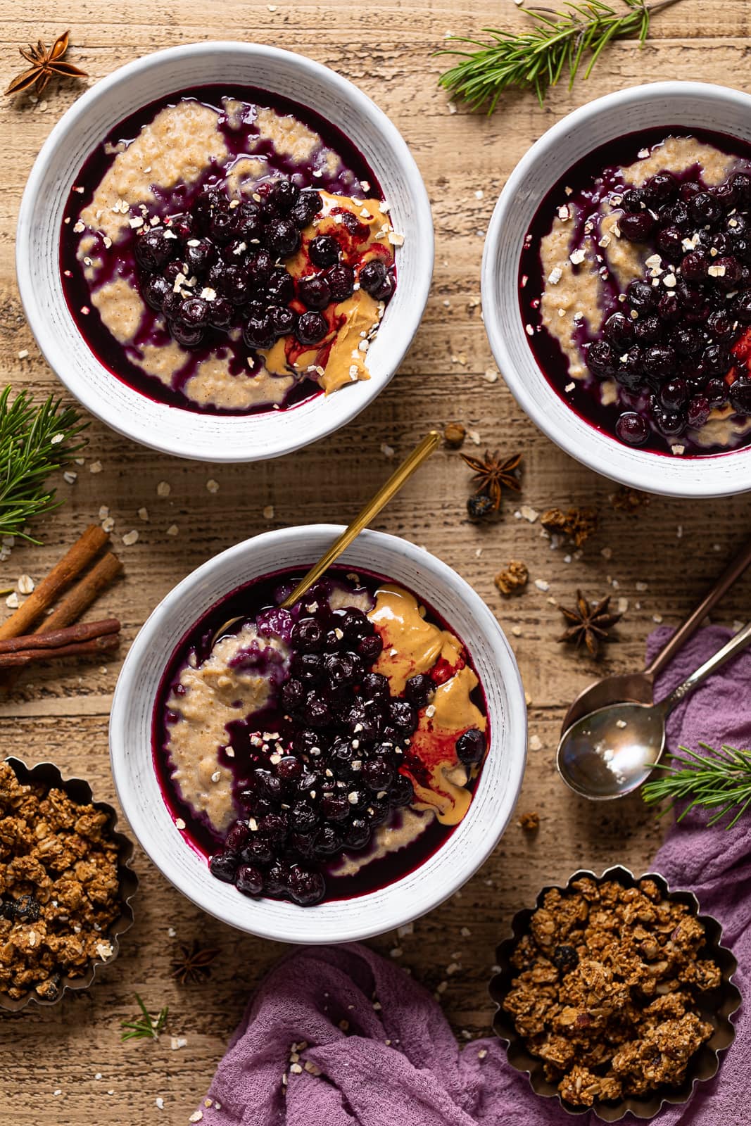 Overhead shot of three bowls of Maple Blueberry Oatmeal Porridge