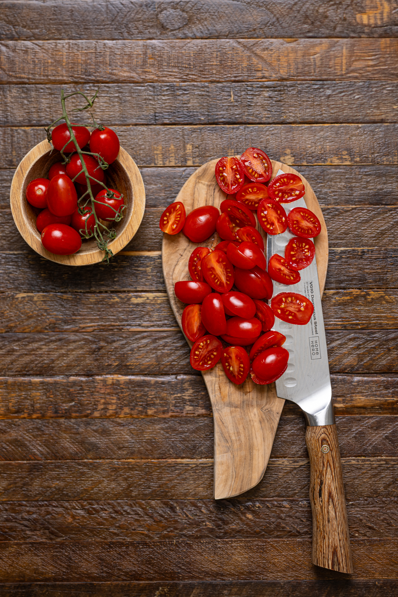 Diced tomatoes on a cutting board with a knife.