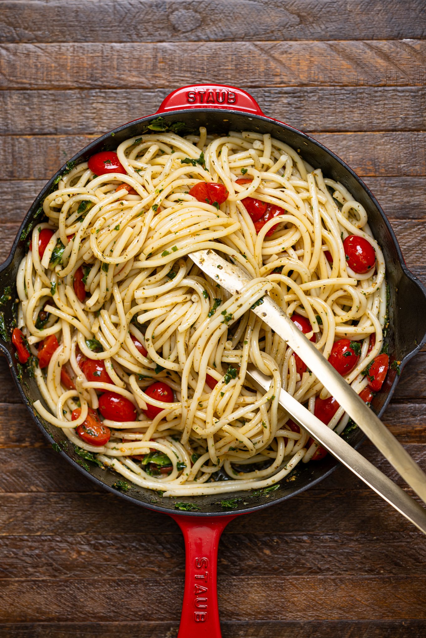 Easy Bruschetta Pasta with Parmesan in a skillet with tongs.