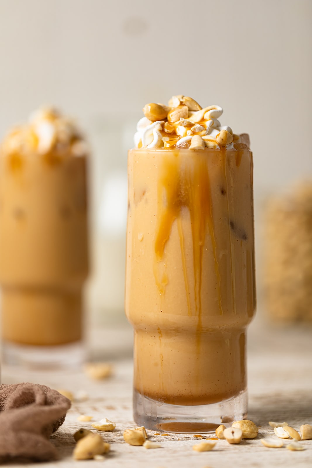 Salted Caramel Cashew Latte in a tall glass with caramel dripping down the side