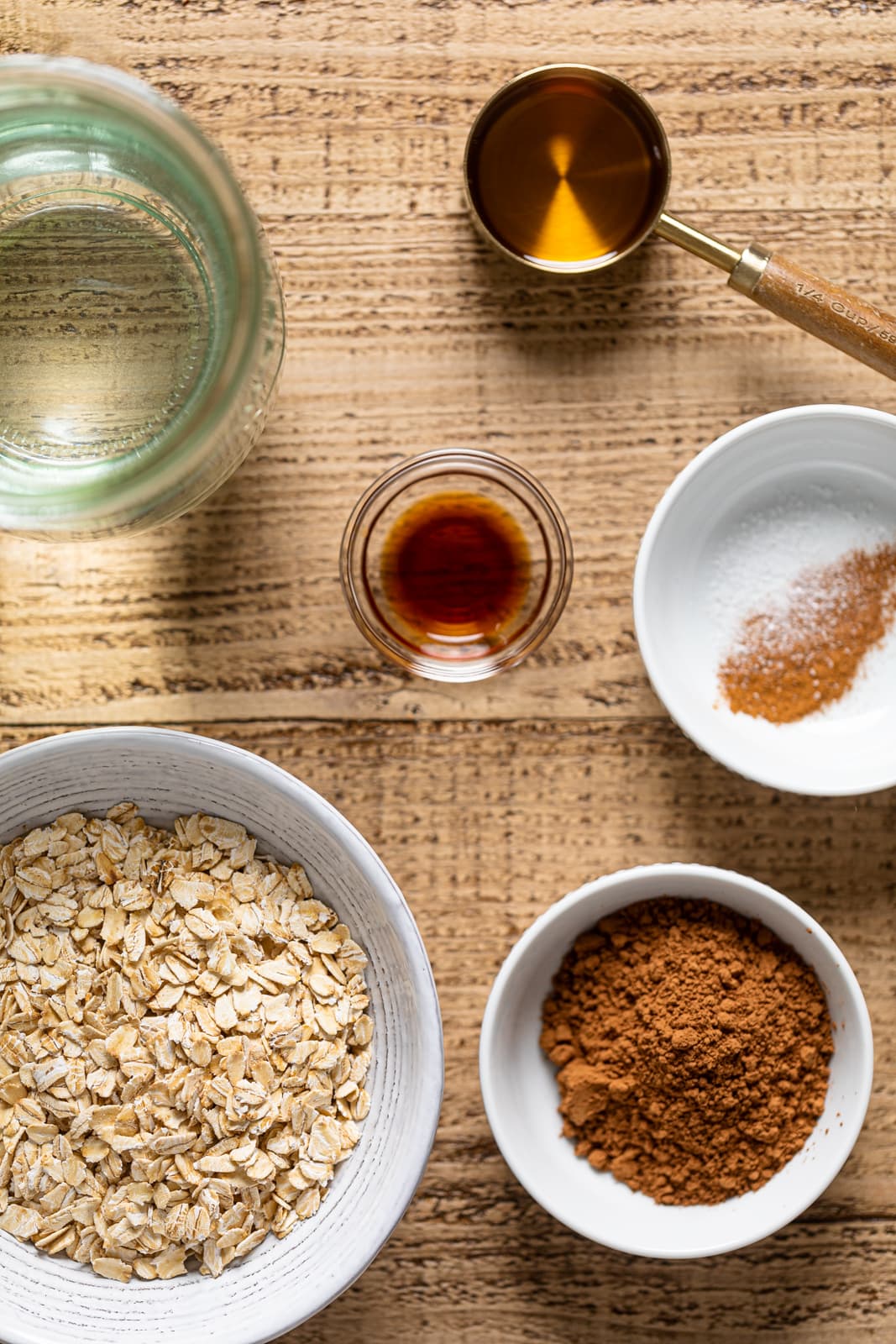 Ingredients for Chocolate Oat Milk including vanilla extract, cocoa powder, and cinnamon