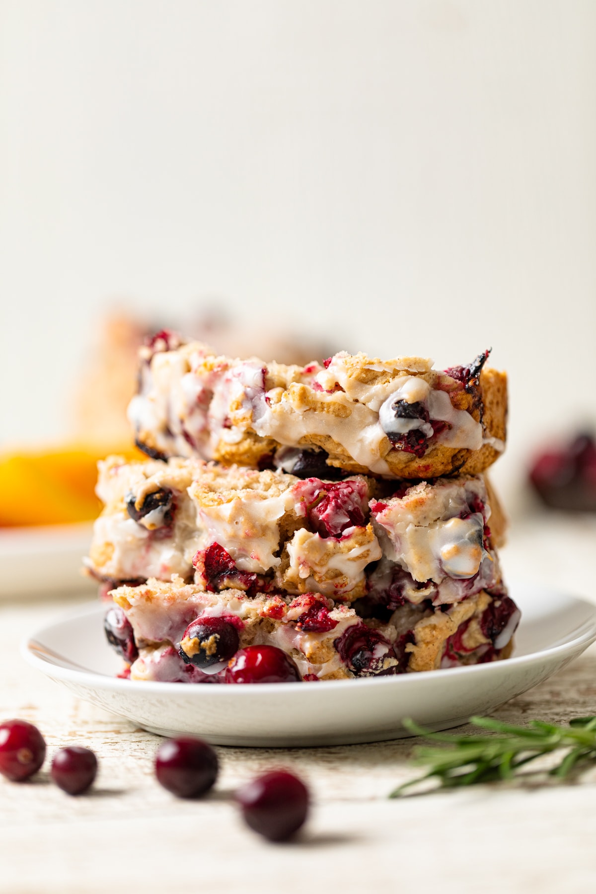 Slices of Vegan Orange Cranberry Bread in a stack on a plate