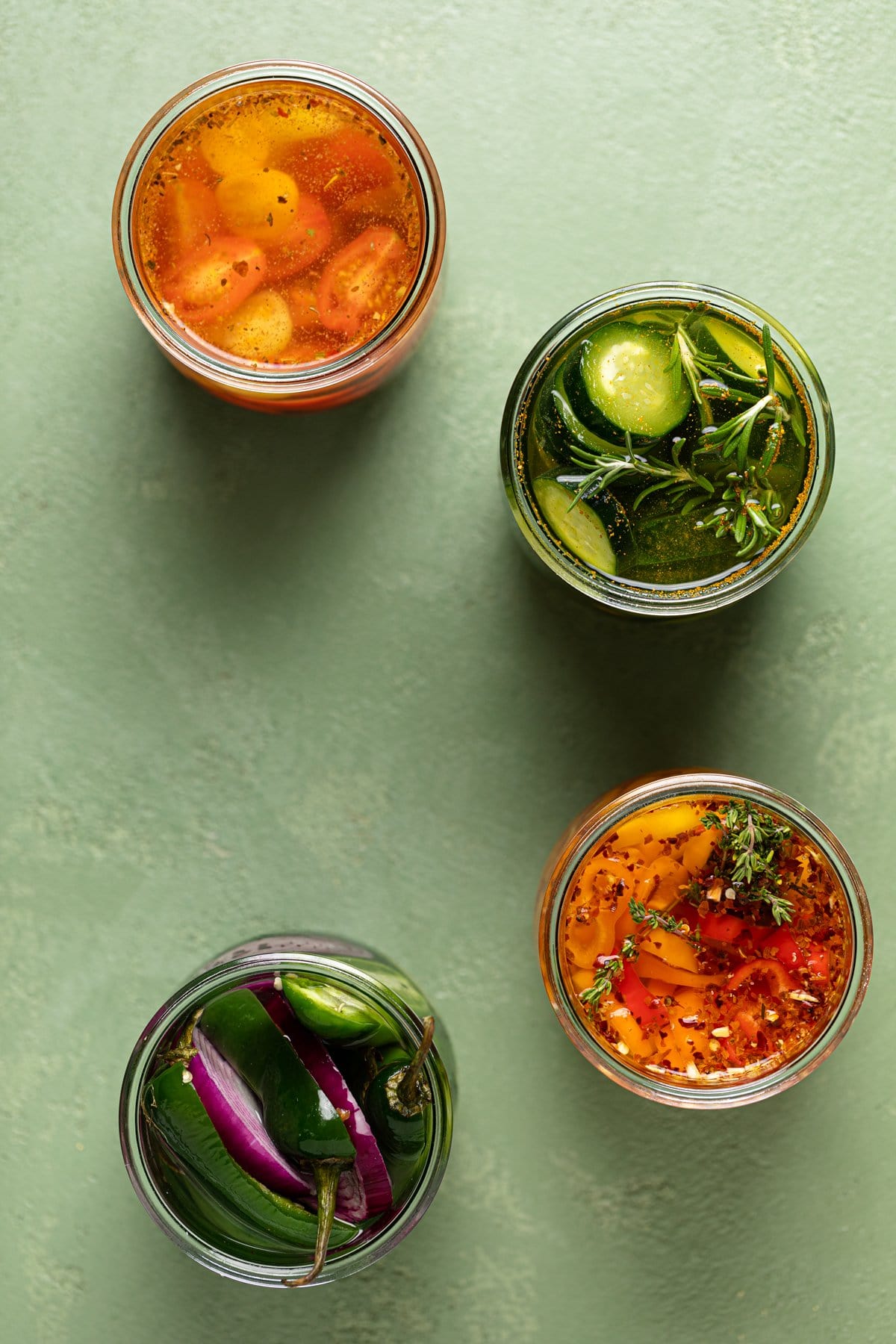 Overhead shot of four jars of quick pickled vegetables