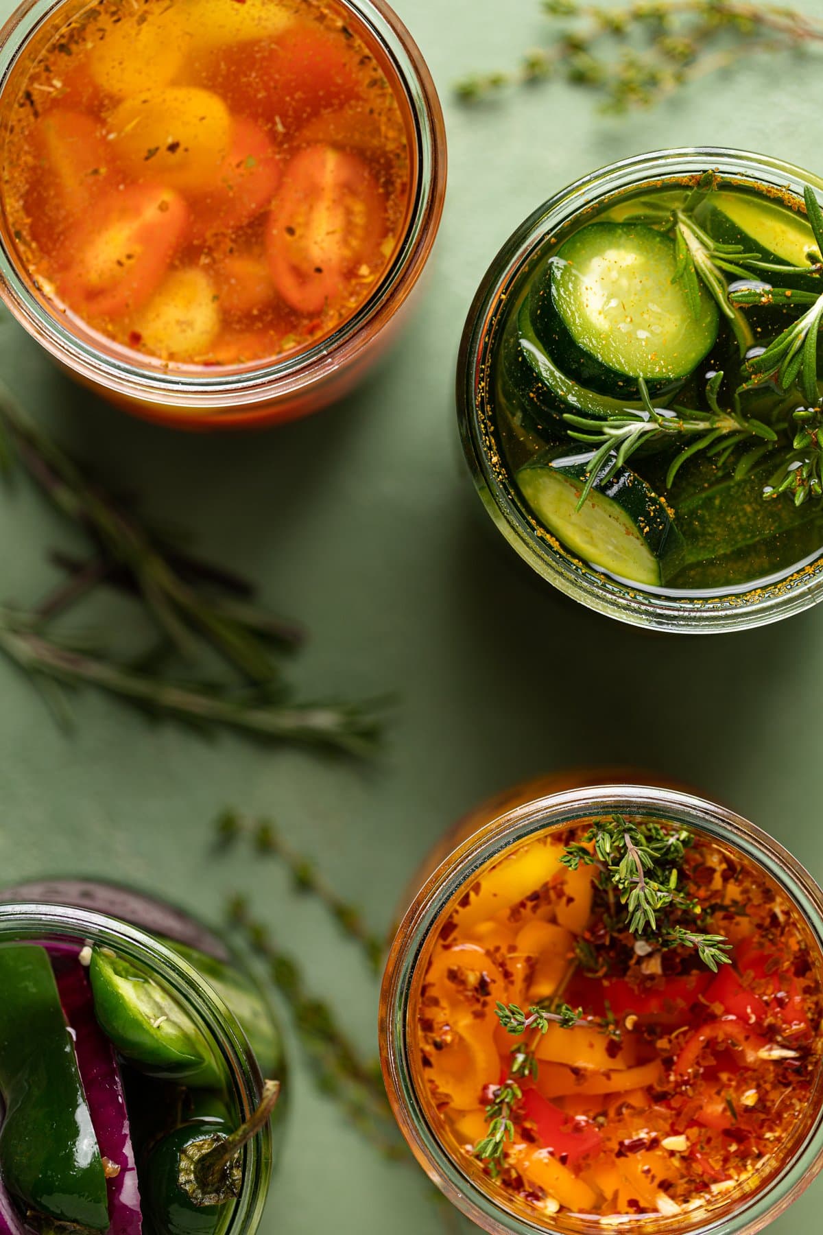 Overhead shot of four jars of quick pickled vegetables