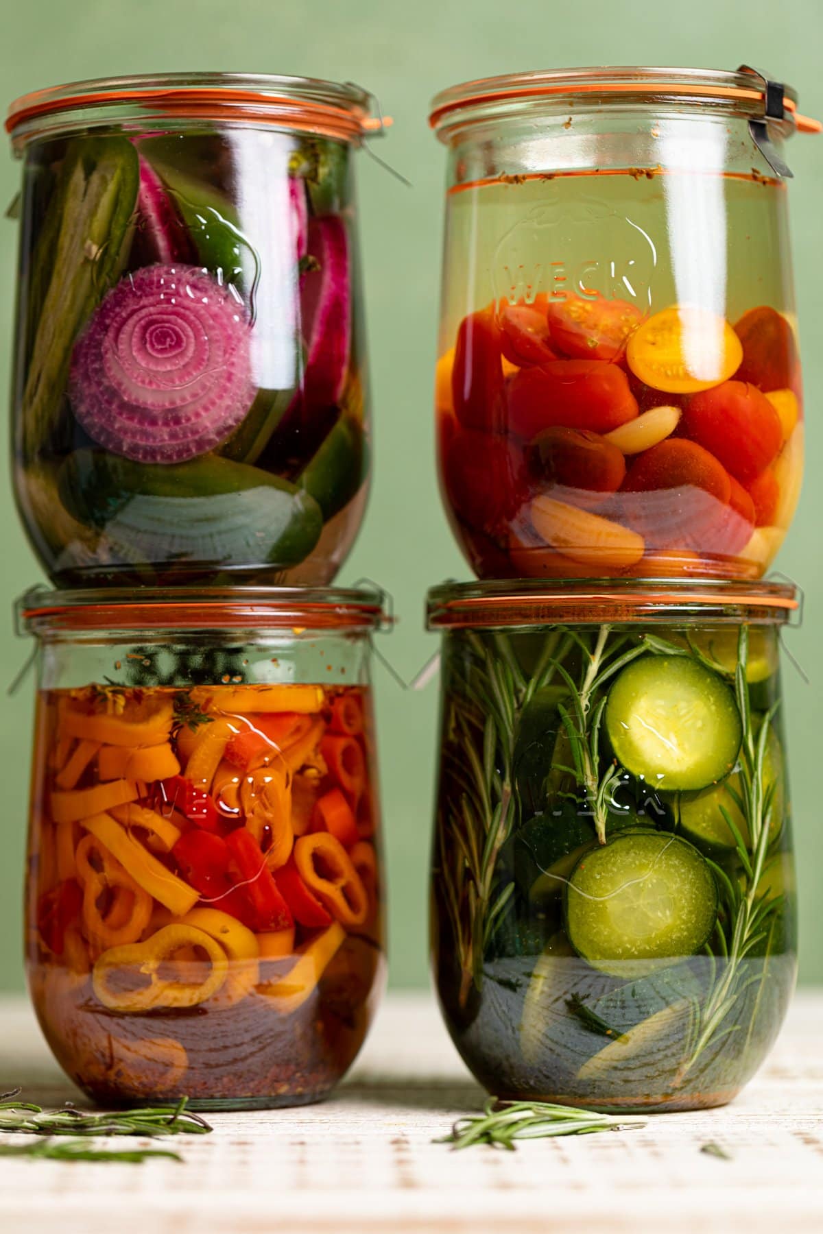 Four jars of quick pickled vegetables in two stacks of two