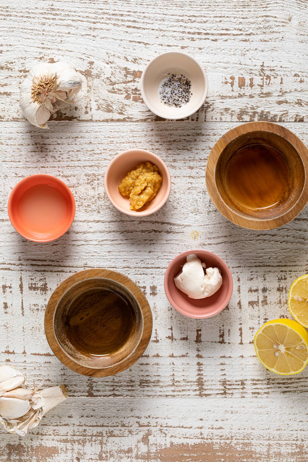 Ingredients for apple cider vinegar dressing including lemon, vegan mayonnaise, salt, and pepper