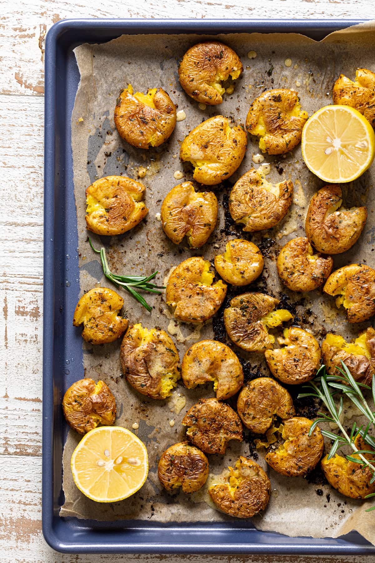 Overhead shot of Garlic Herb Smashed Potatoes on a baking sheet