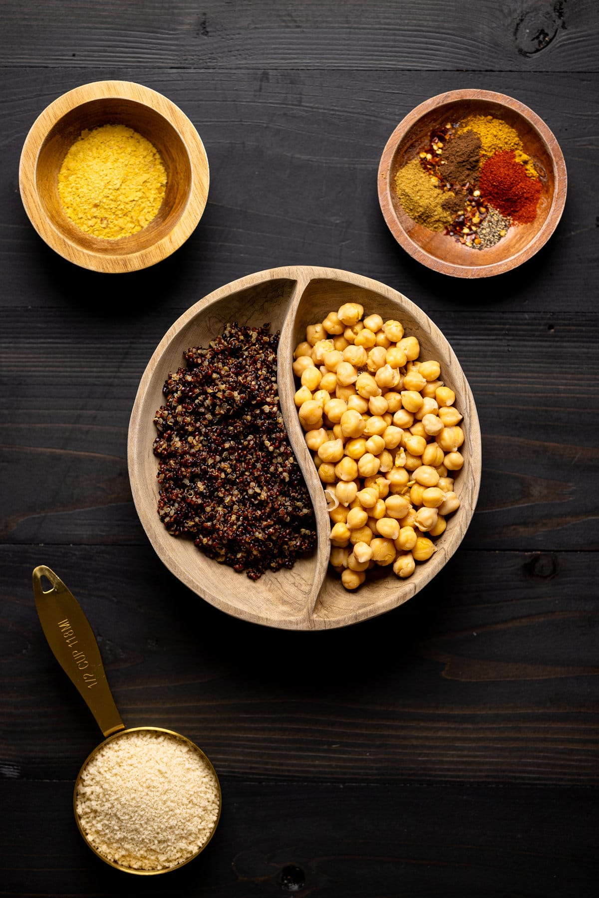 Chickpeas and quinoa in a bowl with bowls of spices
