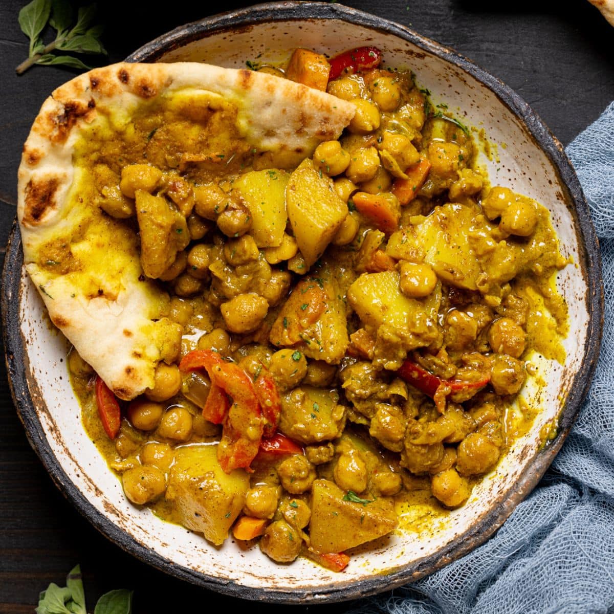 Up close of curry with naan bread.