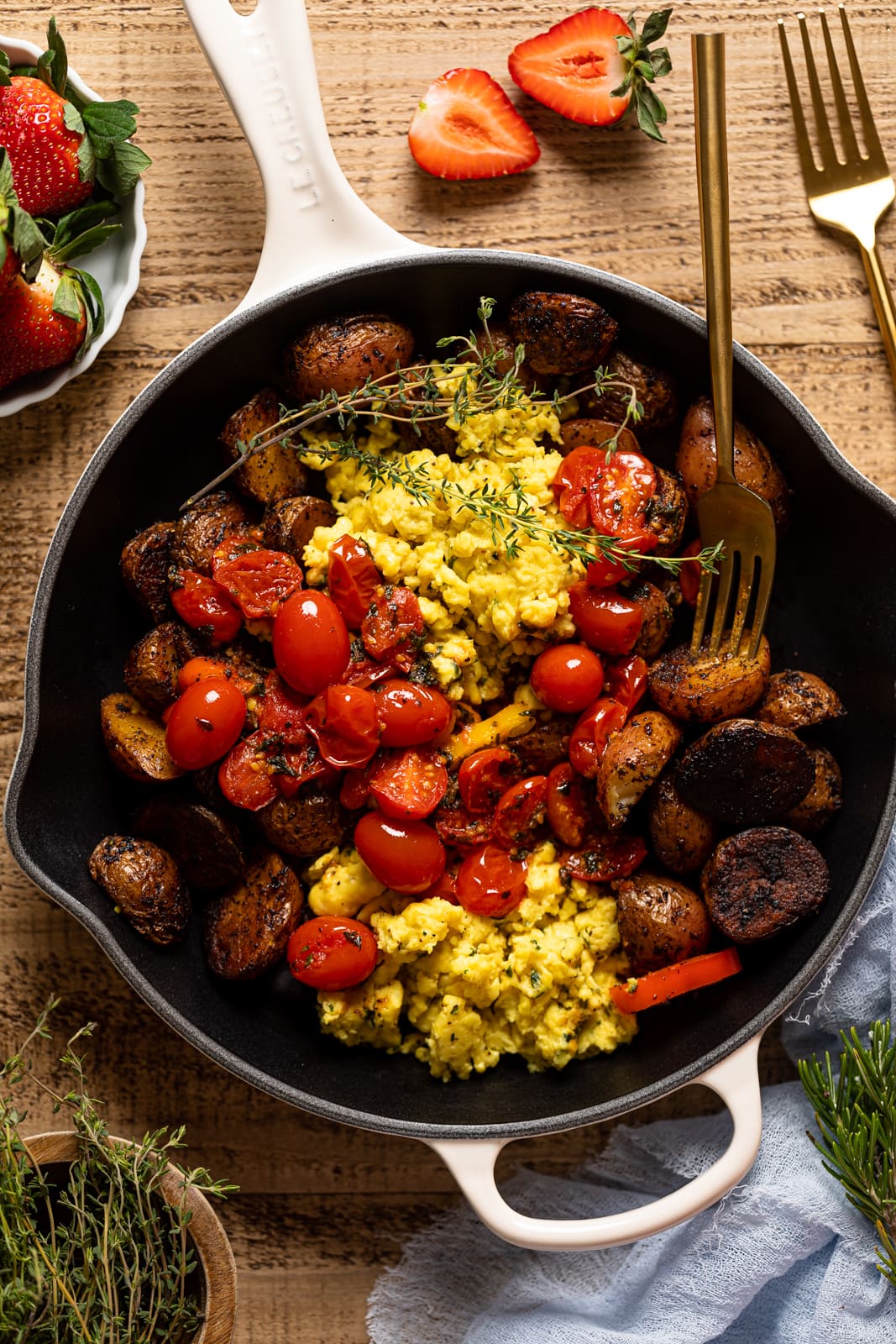 Fork in a skillet of Vegan Breakfast Eggs with Potatoes