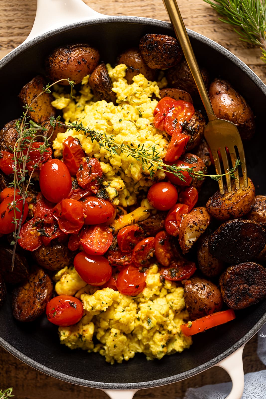 Closeup of a fork in a skillet of Vegan Breakfast Eggs with Potatoes