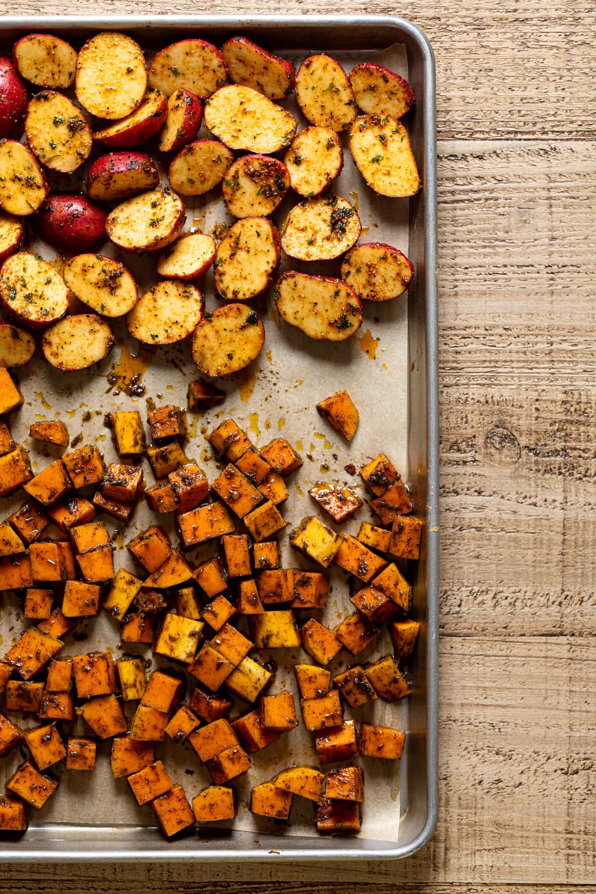 Roasted, chopped, and seasoned vegetables on a baking sheet