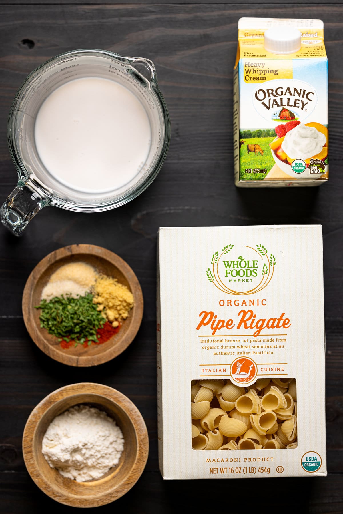 Ingredients for Copycat Velveeta Broccoli Mac and Cheese including noodles, heavy whipping cream, and spices