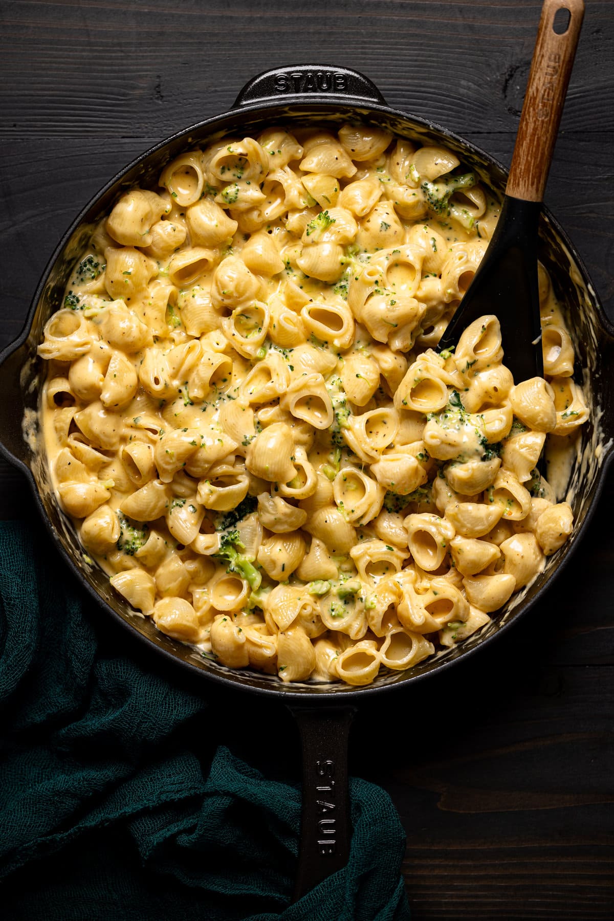 Serving spoon stirring Copycat Velveeta Broccoli Mac and Cheese