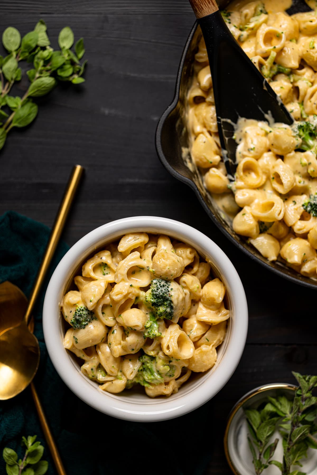 Bowl of Copycat Velveeta Broccoli Mac and Cheese next to a pot