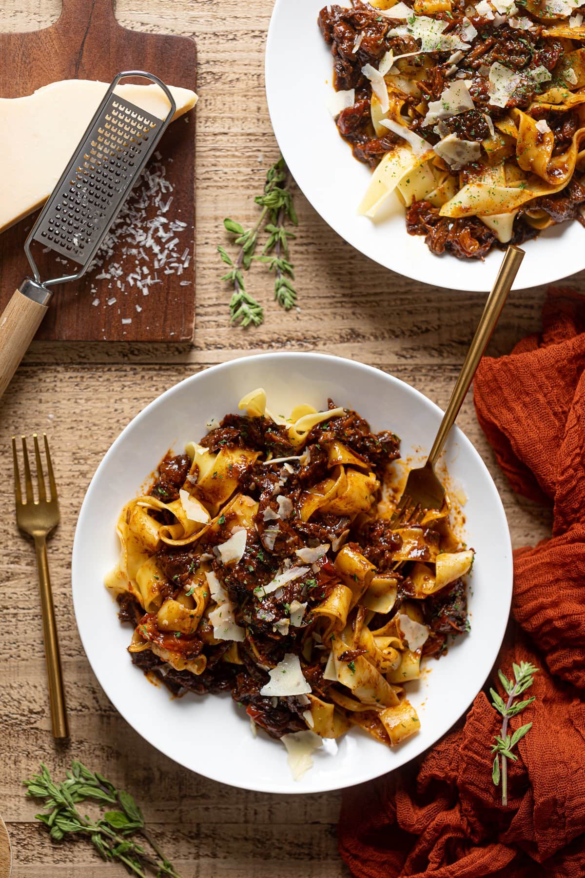 Two plates of Braised Steak Ragu with Pappardelle with parmasean shavings