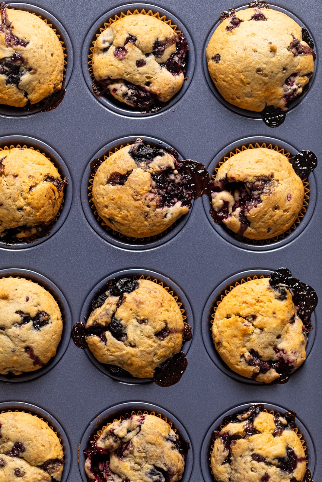 Muffin pan filled with Blueberry Blackberry Jam Muffins
