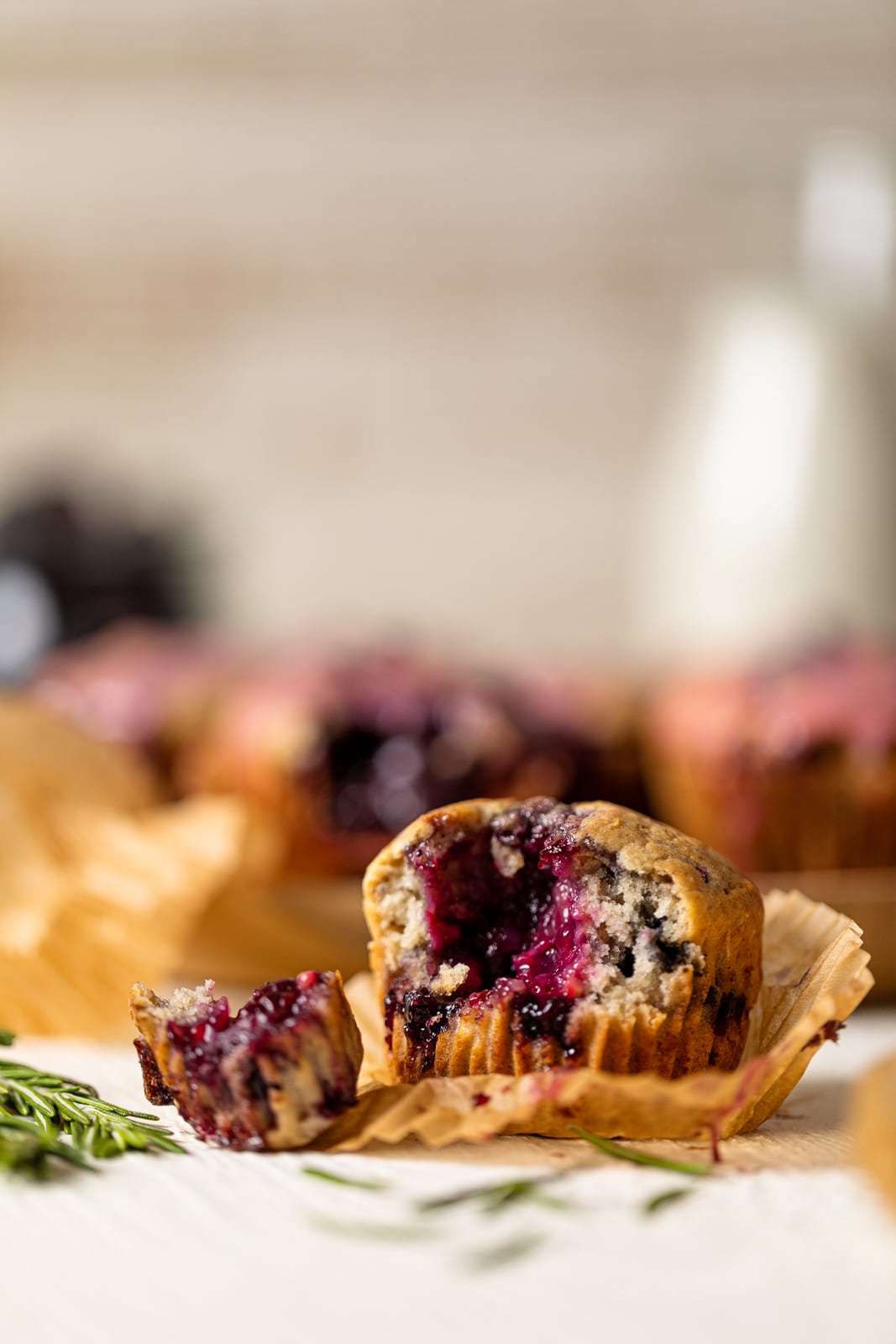 Blueberry Blackberry Jam Muffin with a piece ripped off