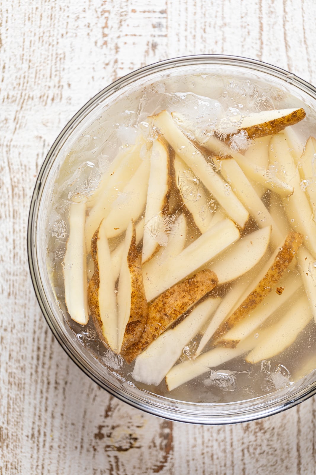 Potato slices in an ice bath