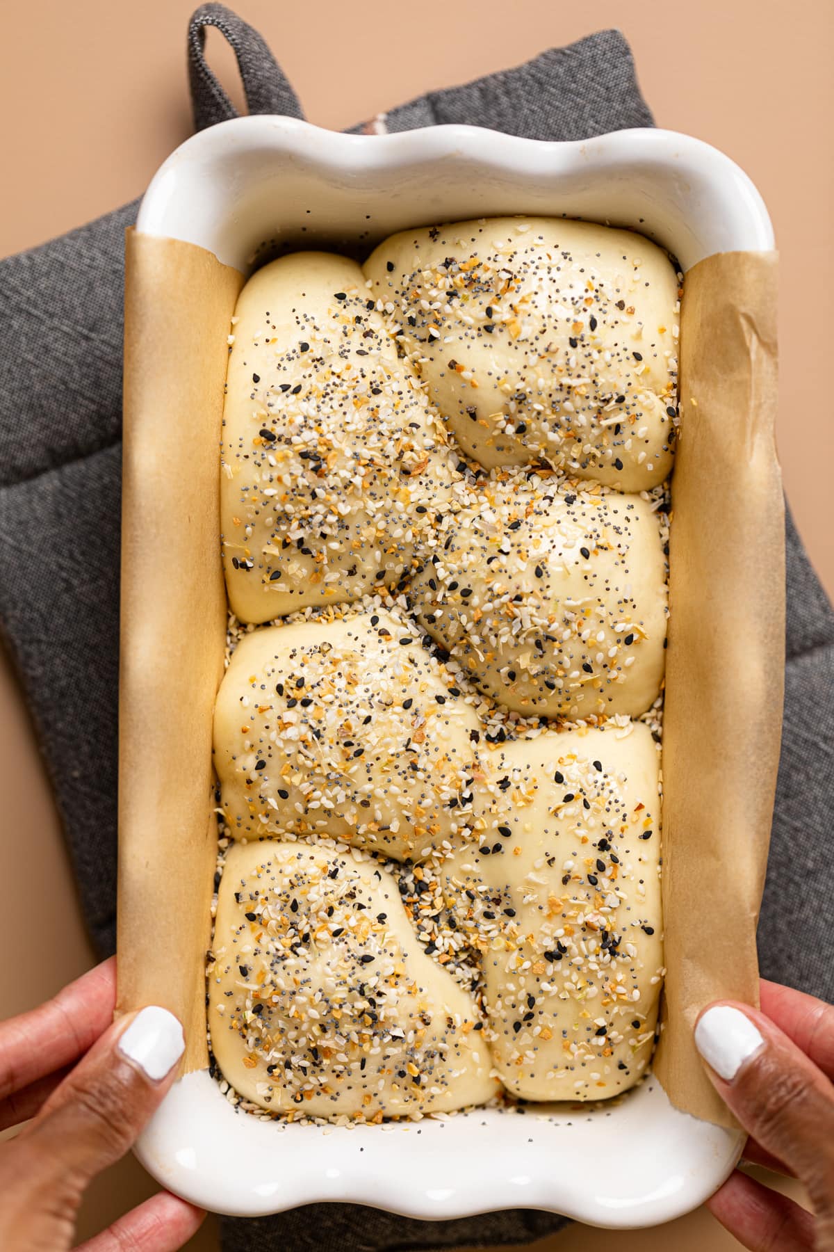 Balls of seasoned Vegan Everything Bagel Brioche Bread packed into a bread pan