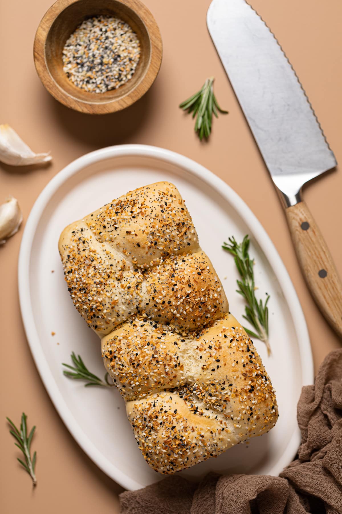 Loaf of Vegan Everything Bagel Brioche Bread on a platter