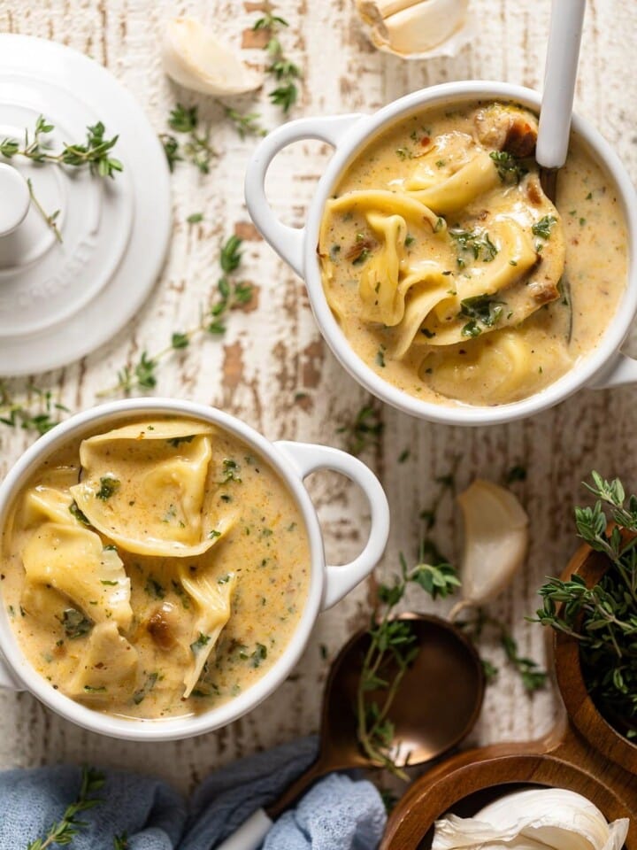 Two handled bowls of Creamy Roasted Garlic Tortellini Soup