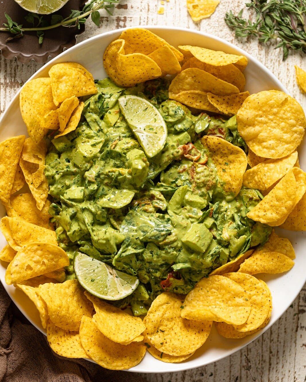 Overhead shot of Green Goddess Salad Dip surrounded by chips