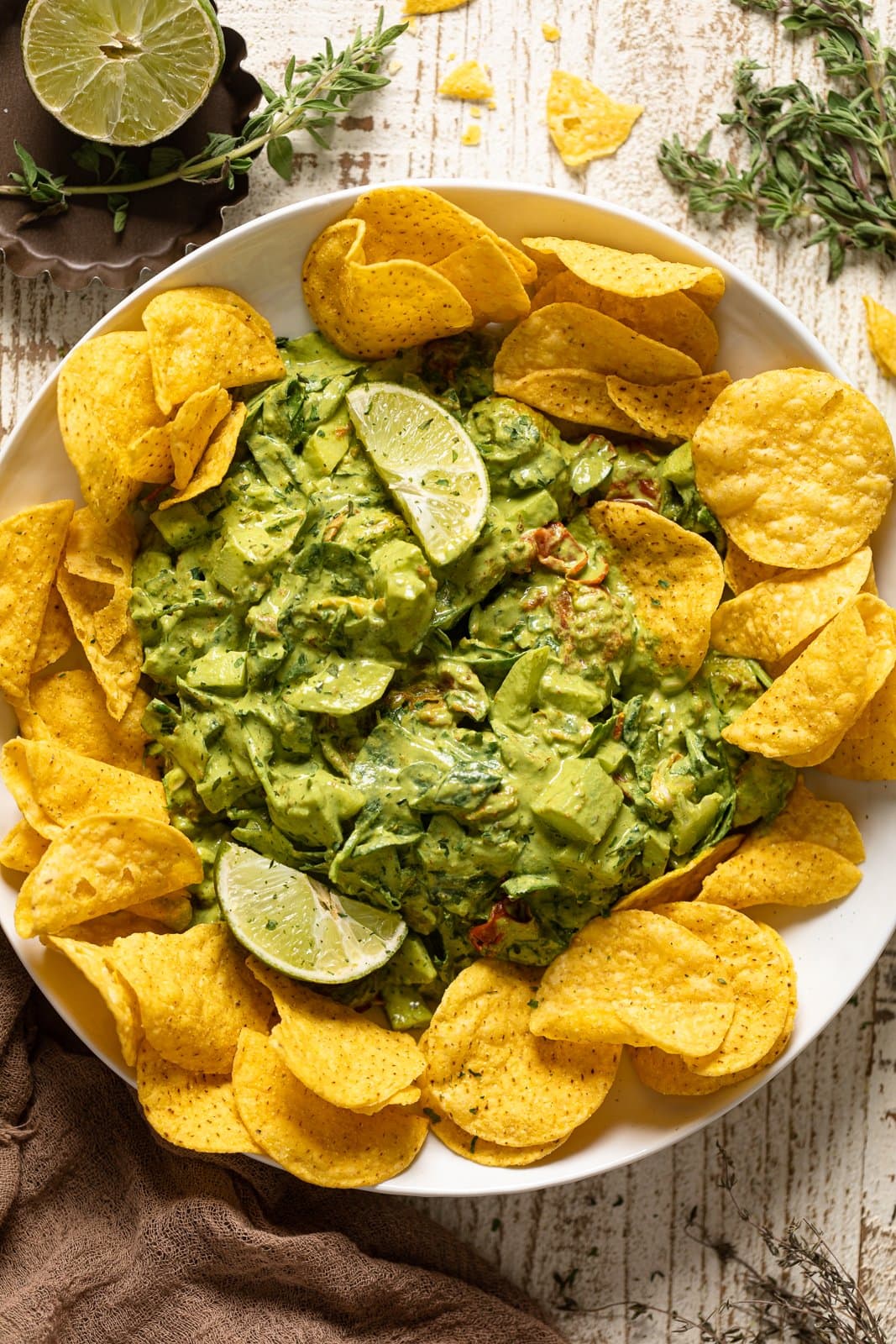 Overhead shot of Green Goddess Salad Dip surrounded by chips