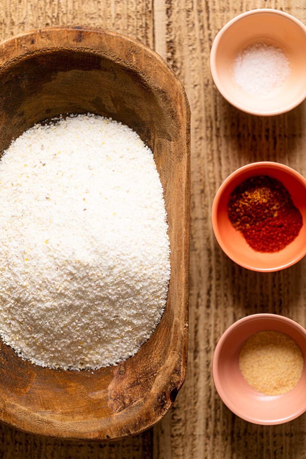 Bowls of dry ingredients including white corn grits, salt, and spices