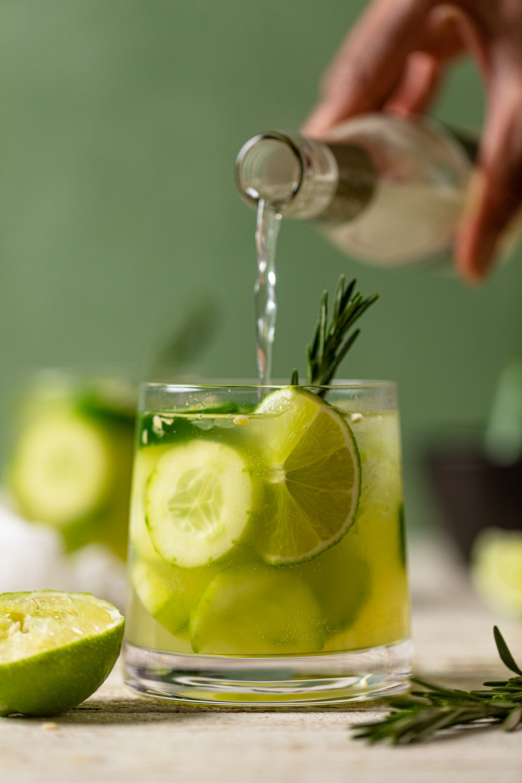 Ginger beer pouring into a Spicy Cucumber Mocktail