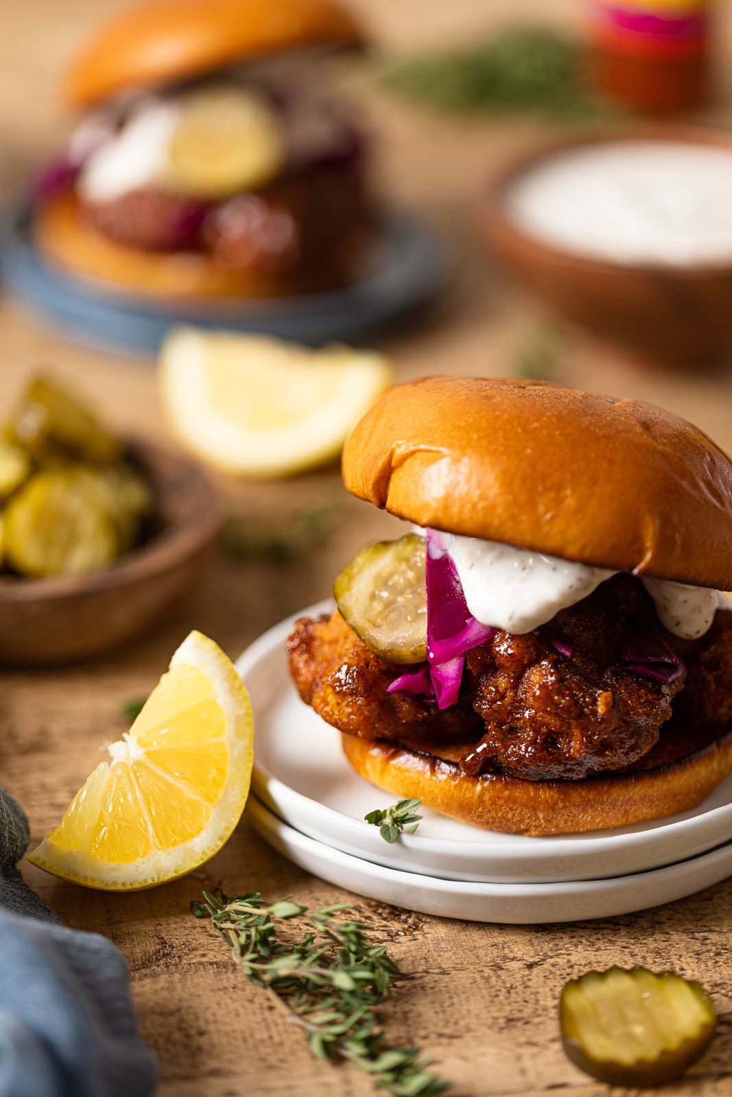 Vegan Chicken Sandwich near lemon wedges and pickle slices