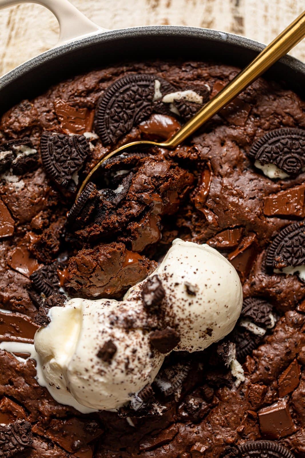 Closeup of a spoon dipping into a Chocolate Oreo Skillet Brownie