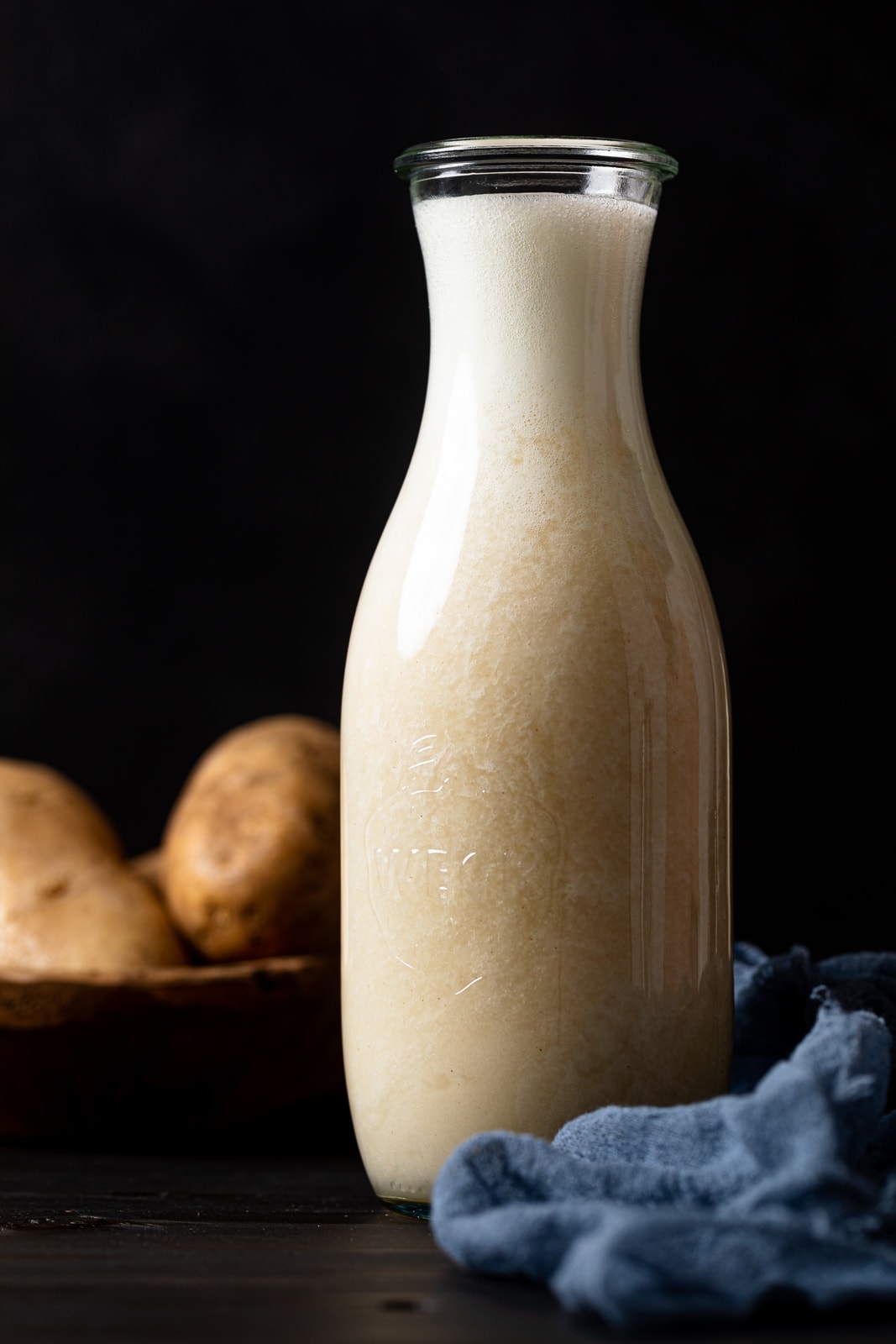 Glass carafe full of potato milk