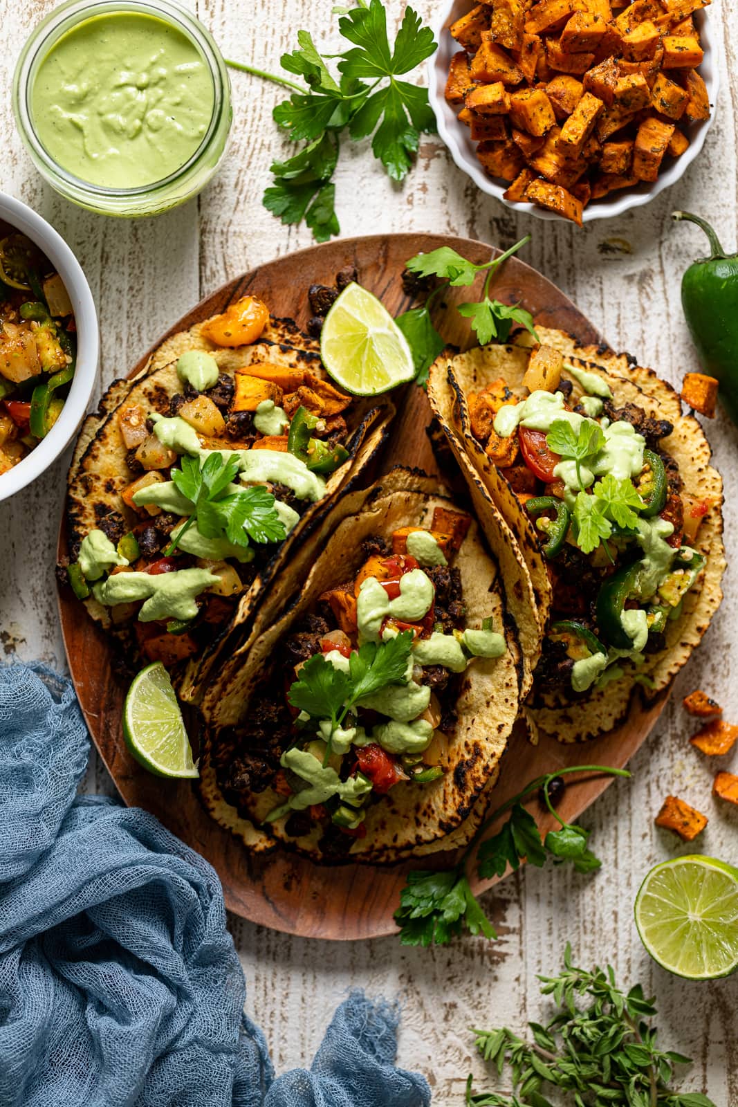 Wooden board with three Roasted Sweet Potato Black Bean Tacos