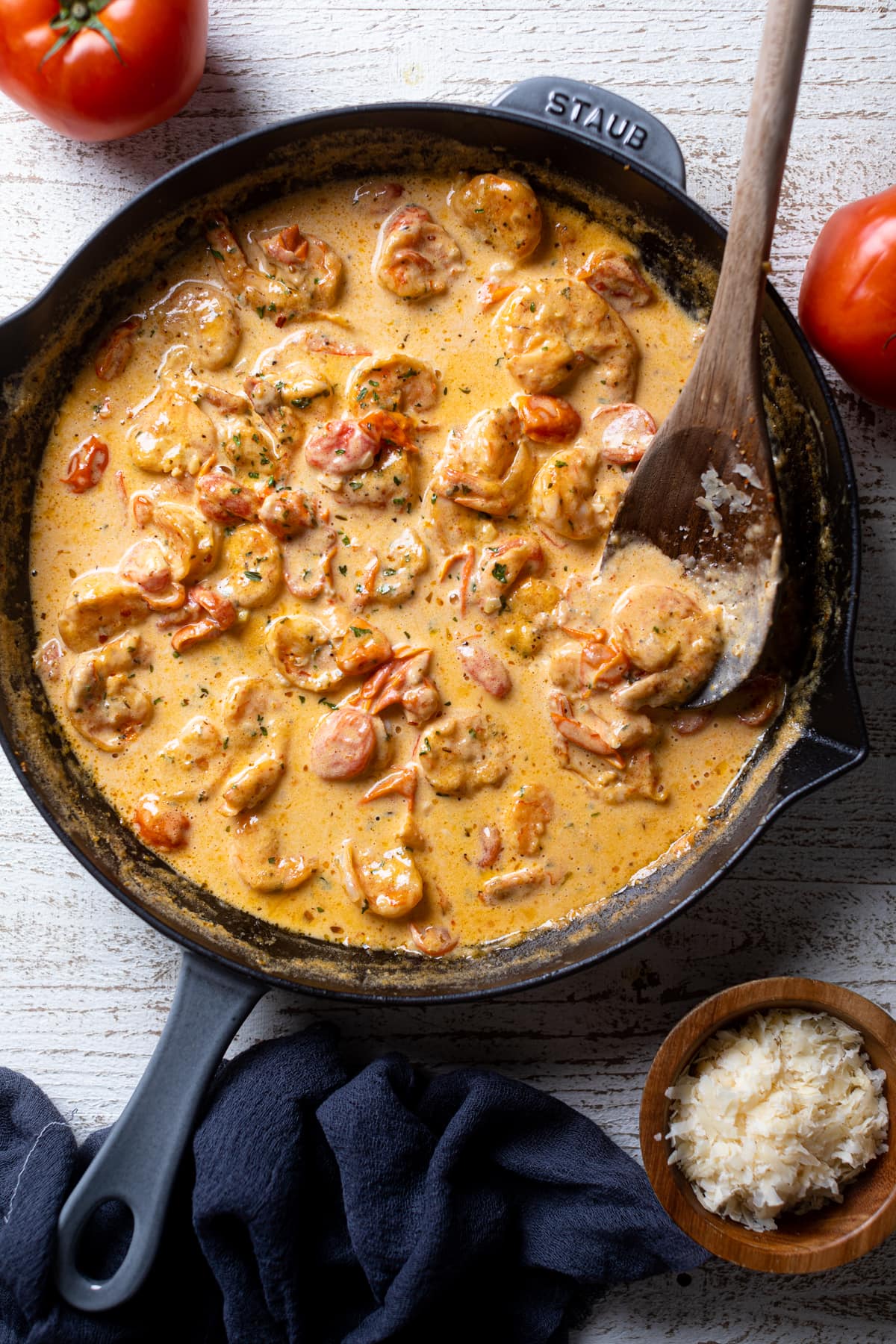 Wooden spoon stirring a skillet of Pasta.