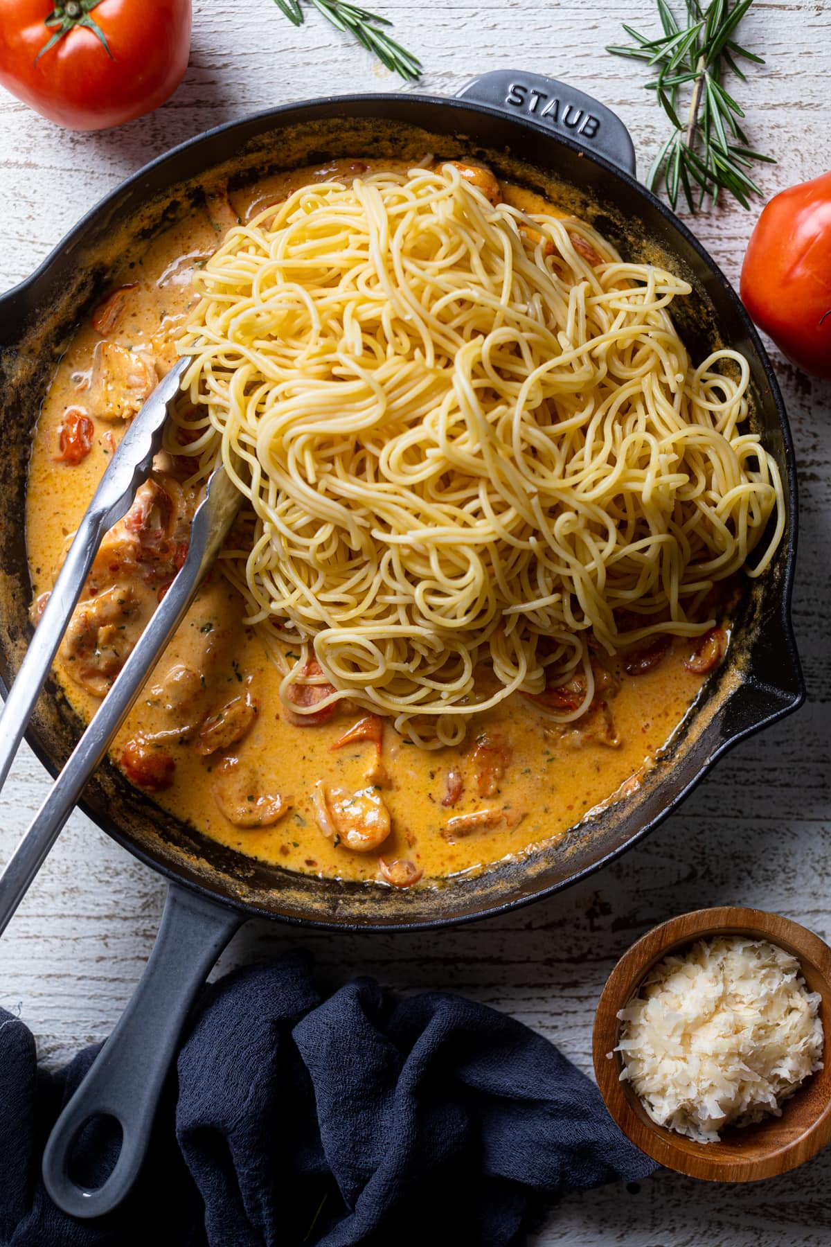  Linguine noodles dumped into a skillet of Parmesan Garlic.