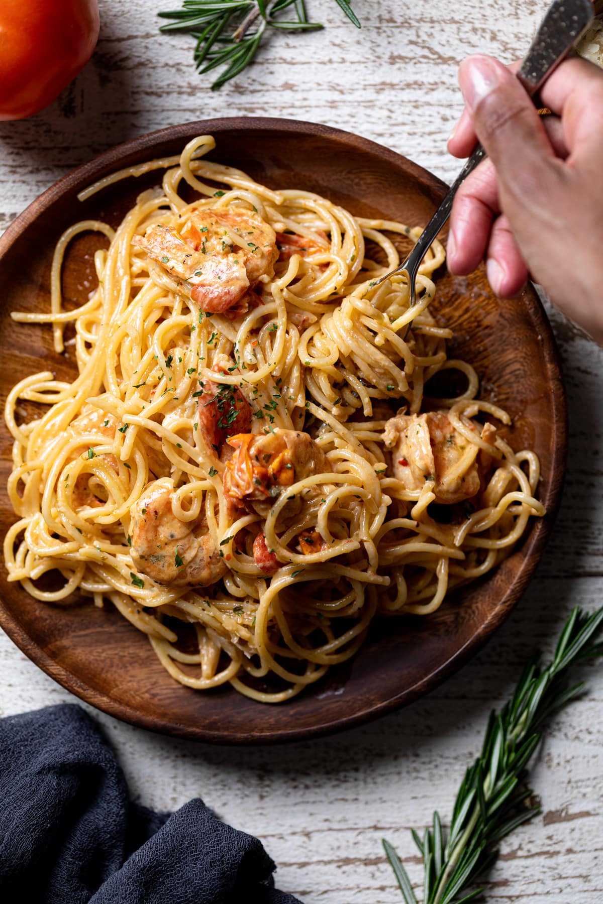 Hand twirling a fork into Creamy Shrimp Scampi Pasta