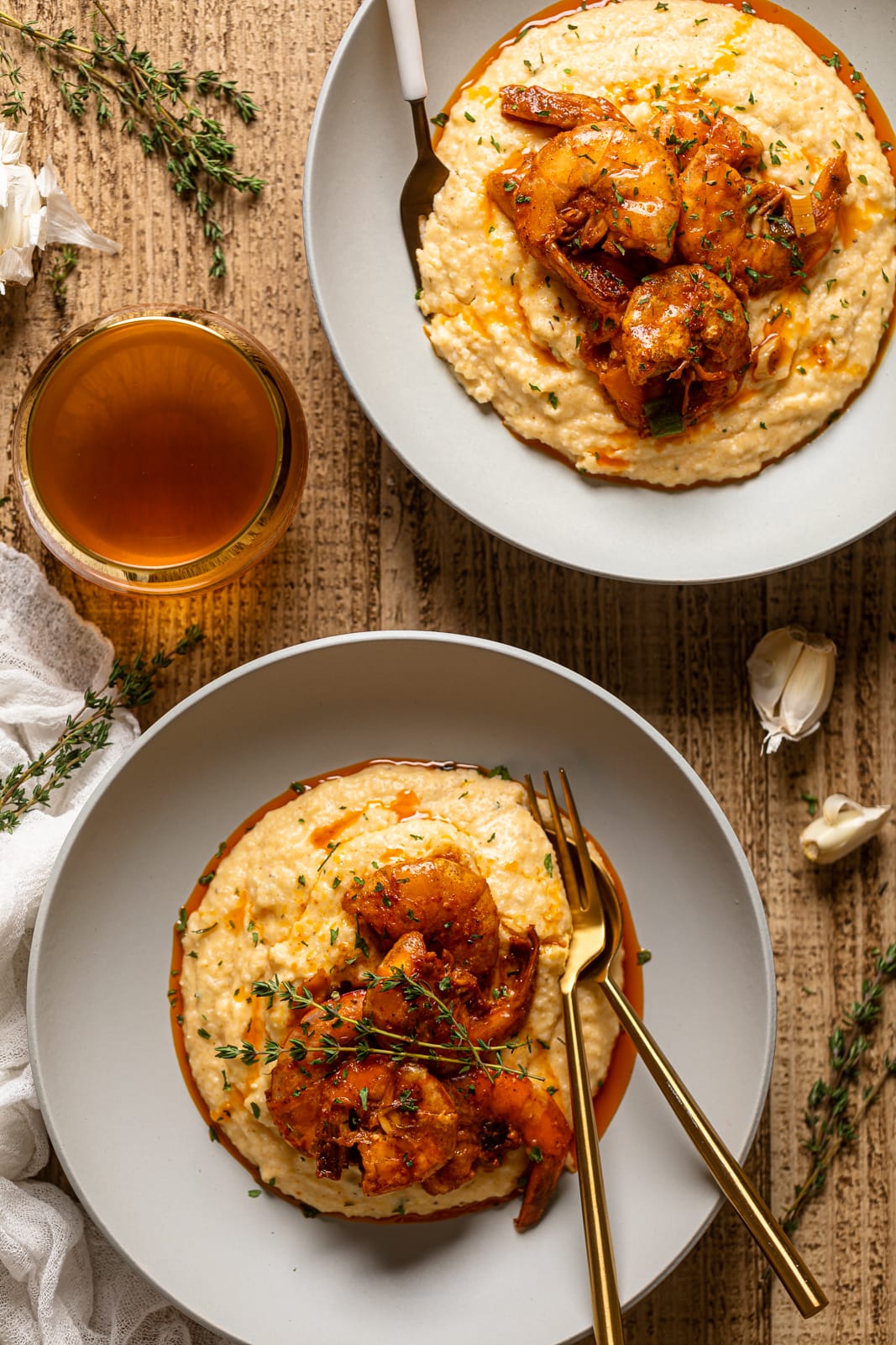 Overhead shot of two plates of Spicy Southern Shrimp and Grits