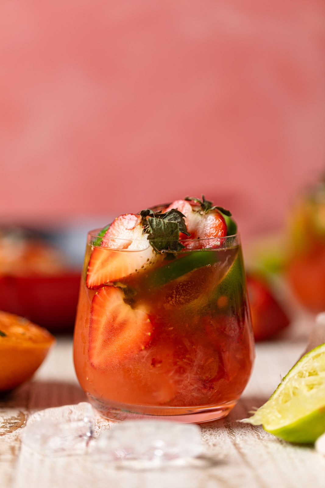 Spicy Grapefruit Jalapeño Mocktail stuffed with halved-strawberries and jalapeno slices