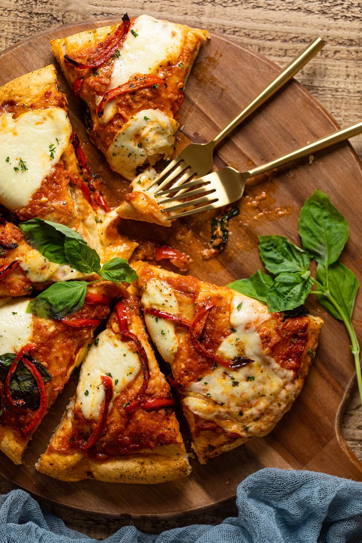 Vodka Pizza on a wooden board missing a few slices