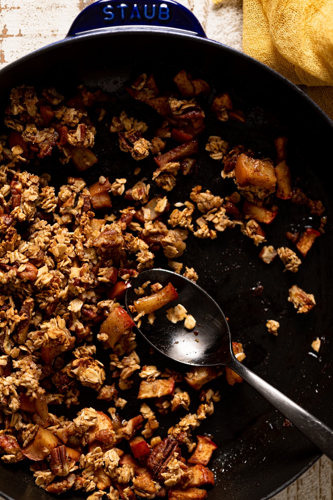 Spoon in a pan of apple crumble