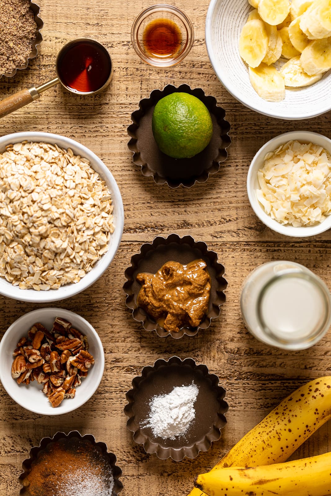 Ingredients for Jamaican-inspired Banana Bread Baked Oatmeal including lime, banana, and coconut flakes