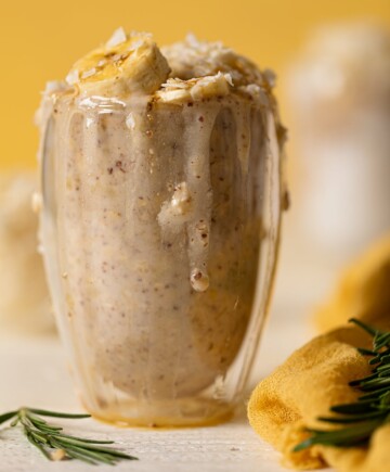 Closeup of an overflowing glass of Banana Coconut Overnight Oats